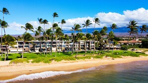 A beachfront hotel with multiple floors, a pool, and palm trees. - Oceanfront, Exceptionally Remodeled, Split A/C, King bed, OH the sunsets (Kihei)