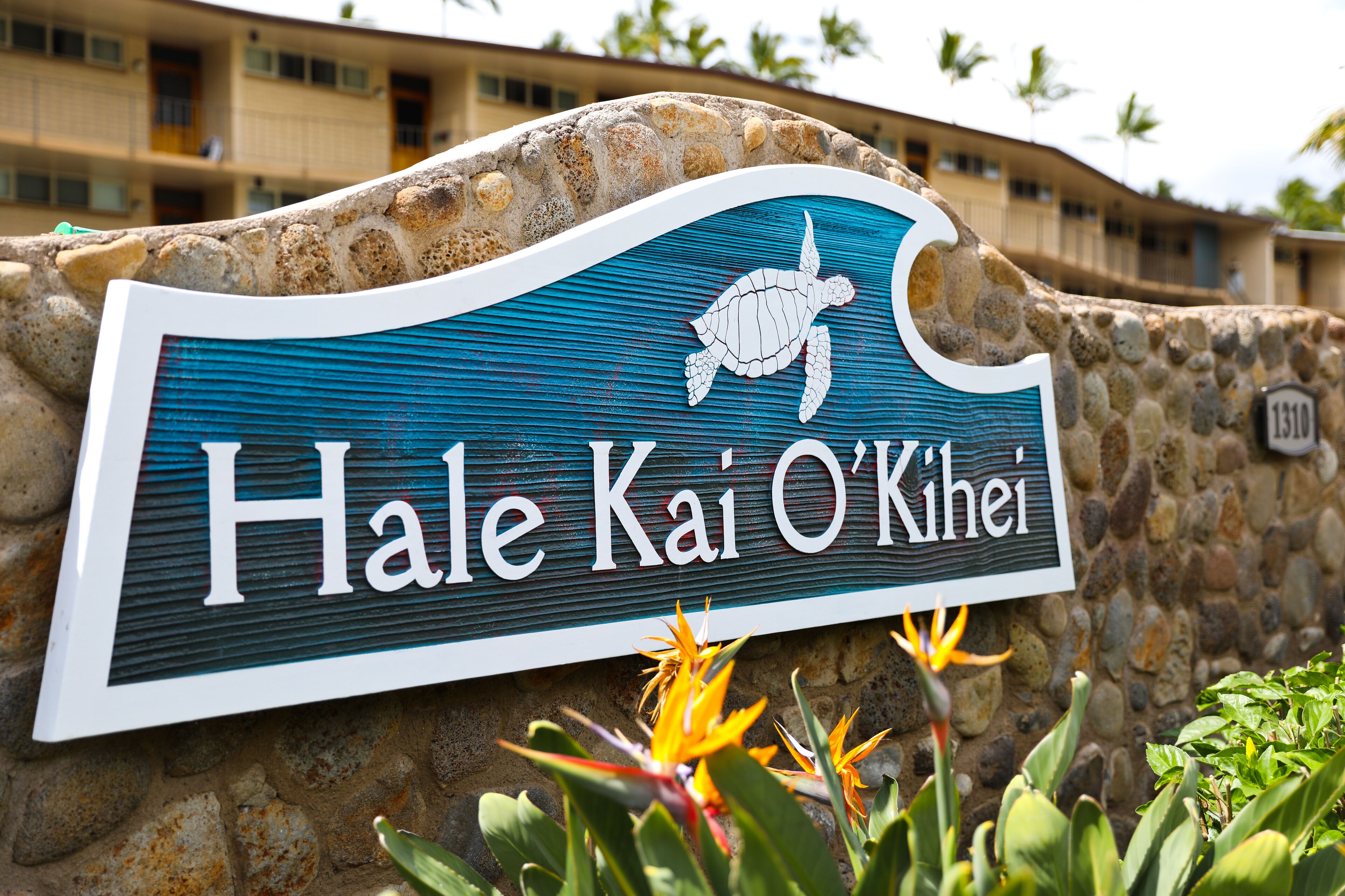 Une enseigne avec une illustration de tortue et le texte « Hale Kai O'Kihei ».