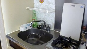 A kitchen with a sink, a gas stove, and a shelf above the sink. - Free bike & free WIFI 203 Take it easy (Kyoto)