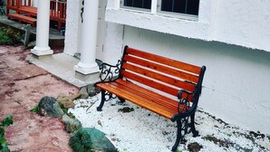 A wooden bench outside a building with white columns and a window. - The standard apartment shibuya D (Tokyo)