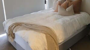 A modern bedroom with a large bed, white bedding, and a bedside lamp. - Executively Inspired - 2 Bed 2 Bath Apt on Queen St with Carpark Fast WiFi Rooftop Pool and Sleeps 5 (Brisbane City)