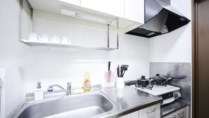 A modern kitchen with stainless steel appliances, a sink, and a stove. - Nestay Suite Tokyo Shibuya (Tokyo)