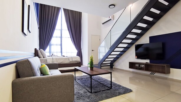 A modern living room with a sofa, coffee table, and a staircase leading to an upper level. - Ekocheras Serviced Apartment by Duke Homes (Kuala Lumpur)
