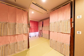 A corridor with padded walls and a ladder, leading to a room with a red curtain. - Nikko Inn Minamisenba 601 - Hostel, Caters to Women (Osaka)