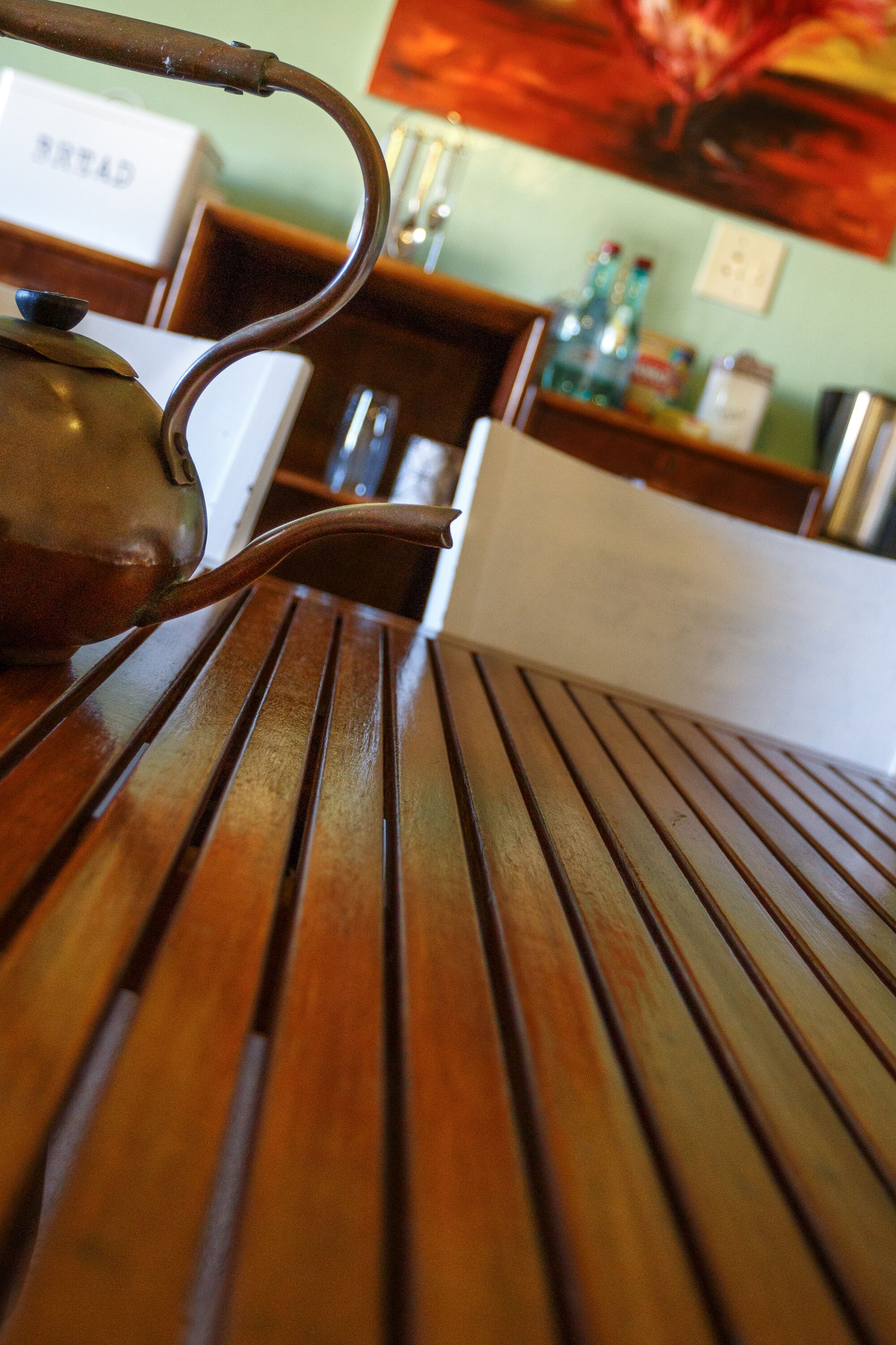 A wooden table with a teapot on it.
