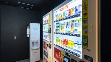 Two vending machines labeled 'KIRIN' with a variety of drinks and a separate 'ICE' machine.