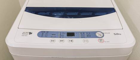 A white laundry machine with a digital display and control buttons.