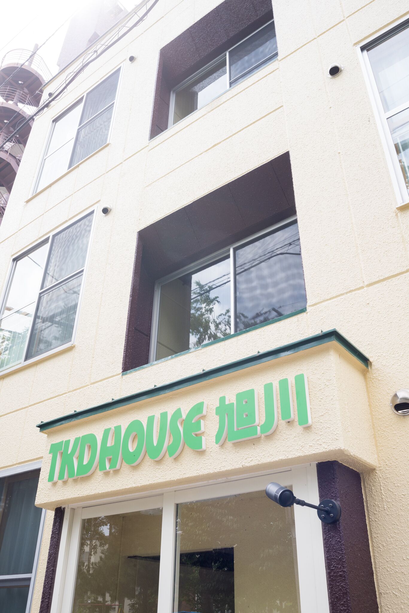 A building with a sign that reads "TKD HOUSE".