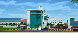 A modern hotel with a prominent tower, multiple buildings, and a well-maintained entrance area. - Hotel Coastal Residency (Namakkal)