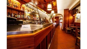 Un área de bar con detalles de madera, una barra y un letrero que dice "elisco".