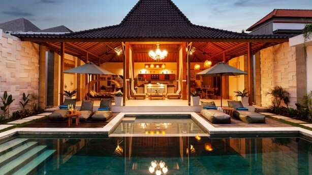 A modern resort with a swimming pool, a covered lounge area, and a dining space with a view of the pool. - Villa Kubu Joglo (Seminyak)