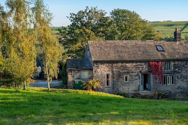 Front view of the property with hills behind