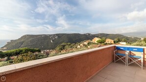 A balcony with a view of a coastal village and mountains. - Il Borgo apartments - A3 (Finale Ligure)