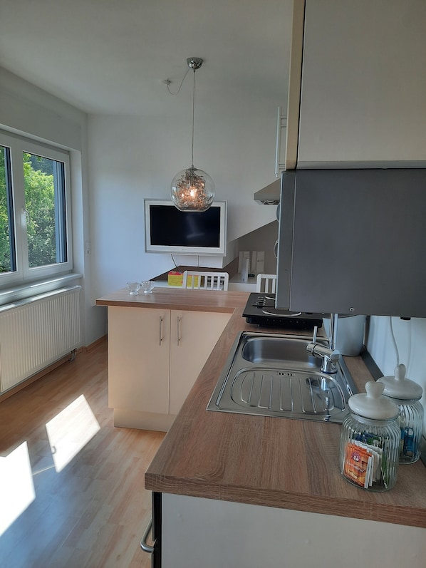 Enjoy cooking in this well-organized kitchen with ample storage and a flat-screen TV above the counter.