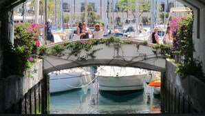 A view through an arched bridge with boats docked below. - Playa De Mogan Miramar (Mogan)