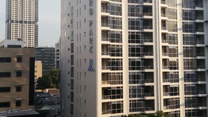 A modern high-rise building with multiple balconies and a prominent 'HYDRO PARK' sign. - Luxury, comfortable and secure home away from home for the best JHB experience (Sandton)