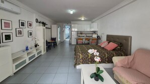 A compact living space with a kitchenette, a dining area, and a bedroom with a bed and a sofa. - Studio Playa Mogan Hungarian (Mogan)