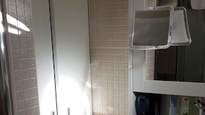 A bathroom with a white sink, a mirror, and a cabinet with toiletries. - Studio Playa Mogan Hungarian (Mogan)