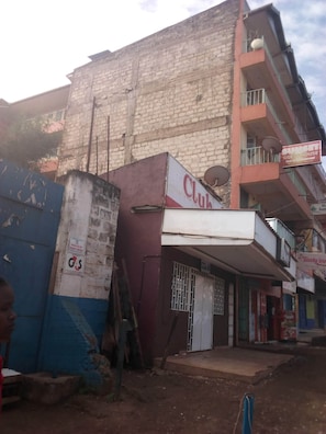 A building with a Club sign, a visible door, and a satellite dish. - Sunset Guest House (Meru)