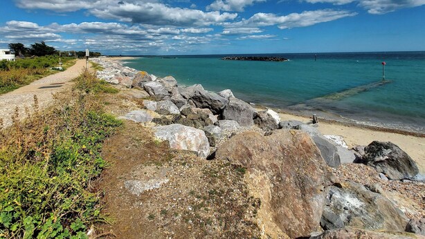 A coastal path with large rocks, a sandy beach, and a clear blue sea. - 5 bedroom accommodation in Elmer, near Bognor Regis (Elmer, near Bognor Regis)