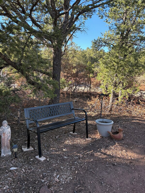 A park bench, a statue, and a planter. - Hiking, mt biking, 44 acres to explore, 20 min outside of Santa Fe (Santa Fe)