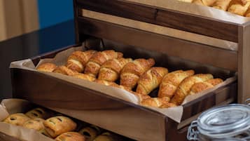 A display of assorted pastries in a wooden box.