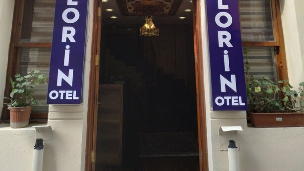 The entrance to LORIN HOTEL with a classic facade, a grand chandelier, and a number 39 sign above the door. - Lorin Otel (Istanbul)