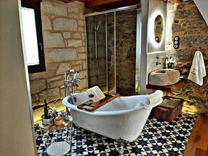 Bathtub, hair dryer, bathrobes, towels