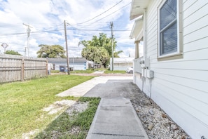 Stroll along the pathway to this charming home, surrounded by a lush garden and a tree-lined neighborhood.