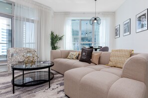Relax in this stylish living room with a comfortable sofa, coffee table, and natural views.