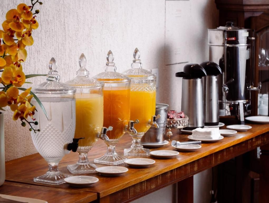 A breakfast bar with juice dispensers and a coffee maker.