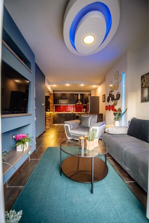 A modern living room with a TV, sofa, and coffee table.