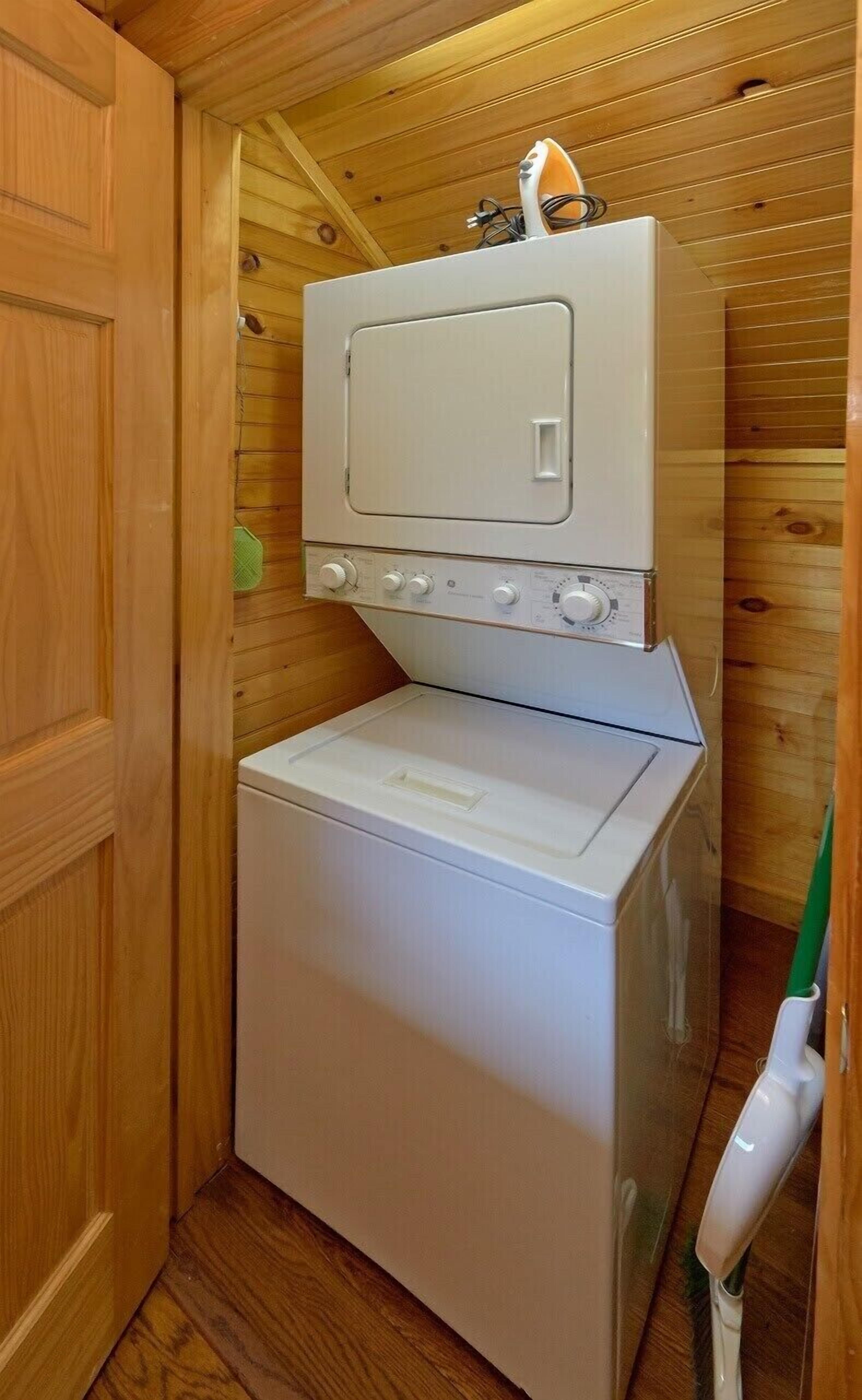 A compact laundry room with a washing machine and dryer stacked on top of each other.