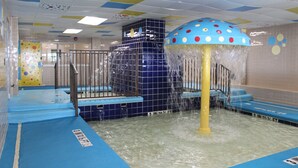 An indoor water play area with a slide and a water fountain. - Holiday Sands South Resort by Palmetto Vacations (Myrtle Beach)