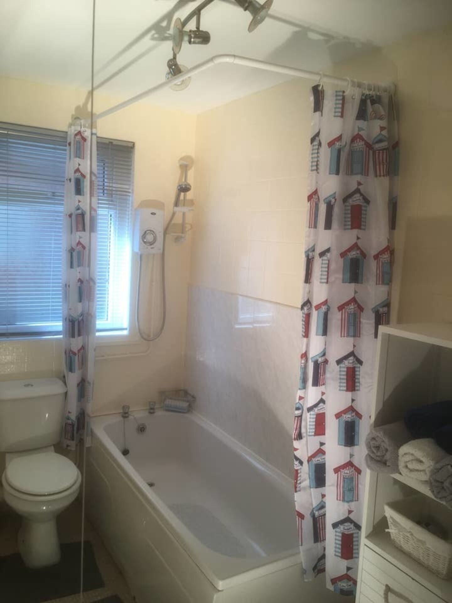A bathroom with a toilet, bathtub, and shower.