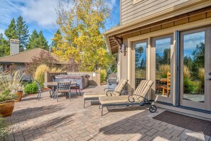 A patio with outdoor furniture, a hot tub, and a grill area. - Pony Express Way 16795 (Bend)