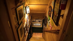 A wooden staircase with a sign indicating Dublin is 3307 miles away. - Log Home in a Peaceful Wood in Jim Thorpe (Jim Thorpe)