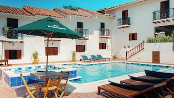 Outdoor pool, open 8:00 AM to 8:00 PM, pool umbrellas