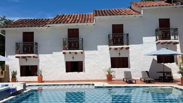 Outdoor pool, open 8:00 AM to 8:00 PM, pool umbrellas