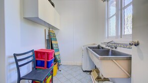 A small, bright kitchen with white walls, a window, and a sink. - Ruby is the precious jewel in the heart of Exmouth. (Exmouth)