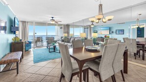 A spacious living area with a dining table, chairs, and a ceiling fan. - On the Gulf-Beach Bum Getaway-Free Beach Chair Setup! (Miramar Beach)