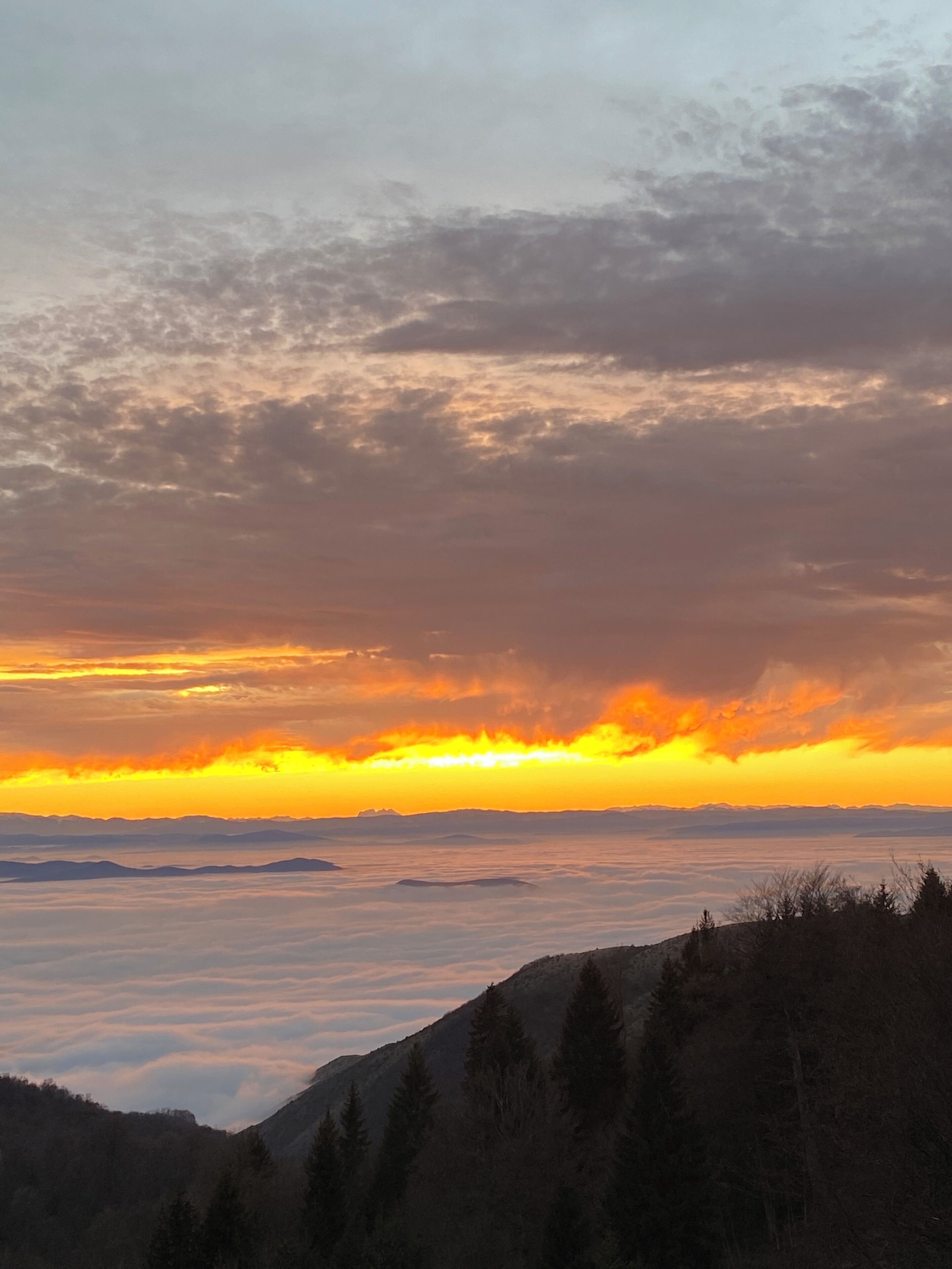A mountainous landscape with a sunset.
