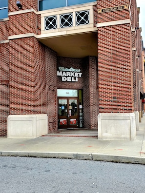 Main Street Market Deli building features a symmetrical facade with a central entrance and decorative brick pattern.