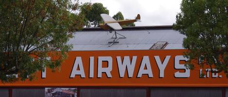 A building with an orange sign reading "AIRWAYS LTD." and a small airplane model on the roof.