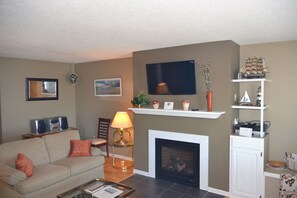 Condo 100 By Winfield Inn | Living area | 40-inch LCD TV with digital channels, TV, fireplace