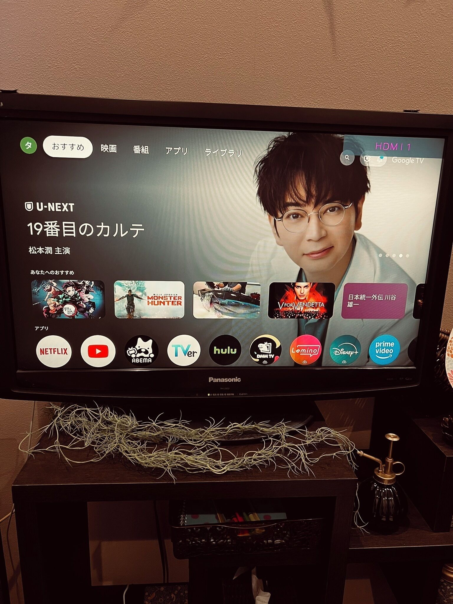A television displaying a streaming service interface with multiple content options and a visible Netflix logo.