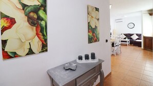 A living room with a dining area, a sofa, a coffee table, and a TV. - 1155 Apartment SanJuan 18 (Nerja)
