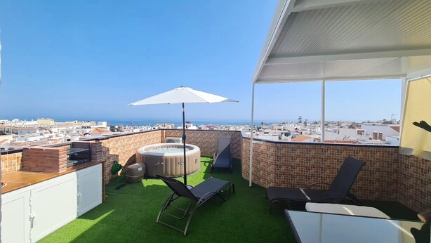 A rooftop terrace with a hot tub, lounge chairs, and a view of the city. - 1155 Apartment SanJuan 18 (Nerja)