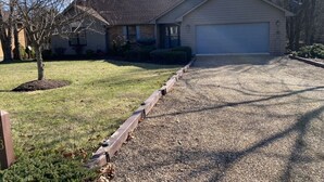 A residential driveway leading to a garage, with a lawn and a tree on the left. - A Den for all four seasons, visit the Bear's Den and create lasting memories. (McGaheysville)