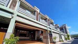 A modern building with a covered entrance, a motorcycle parked outside, and a clear blue sky. - Professor's House 2198 (Ji'an)